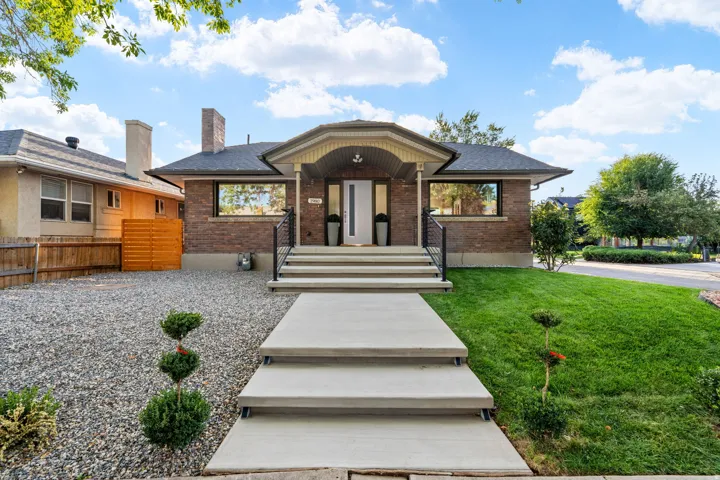 Brick exterior with a prominent arched entry and covered porch *front door is rendered*