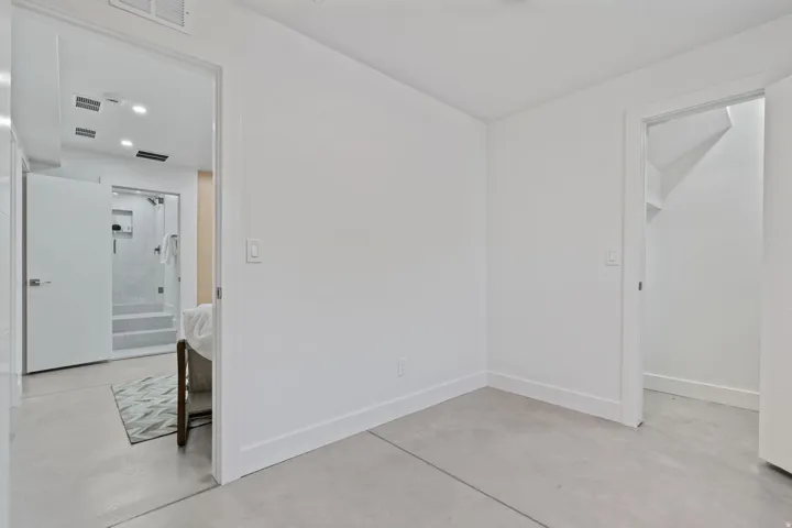 Concrete flooring throughout, white walls, and bright overhead lighting