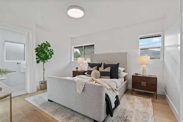 Light wood-finish flooring, white walls, and recessed lighting