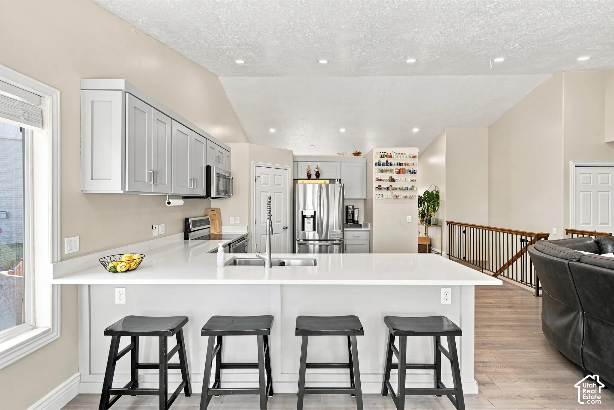 Kitchen featuring light-toned cabinetry, light-toned countertops, and stainless steel appliances
