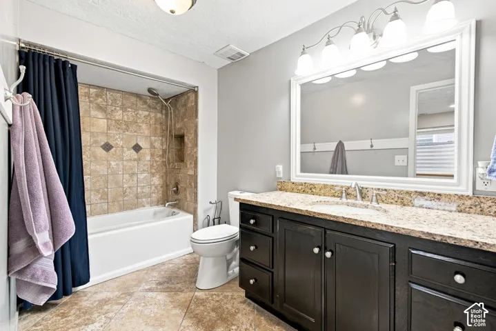 Full vanity with a light-colored countertop, undermount sink, and polished chrome faucet