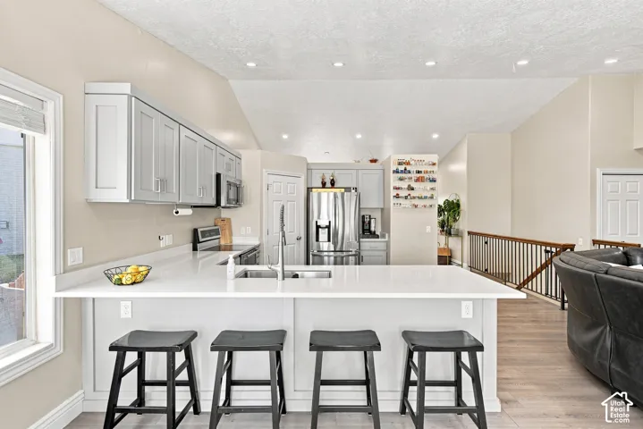 Kitchen featuring light-toned cabinetry, light-toned countertops, and stainless steel appliances