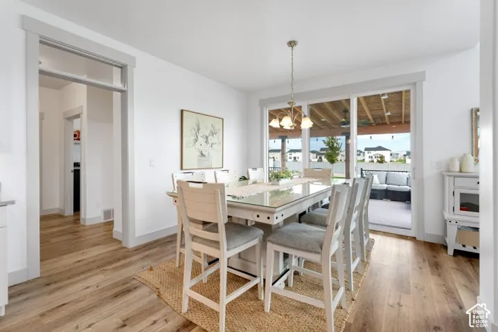 Wood-finish flooring throughout, bright white walls, and a recessed ceiling light fixture