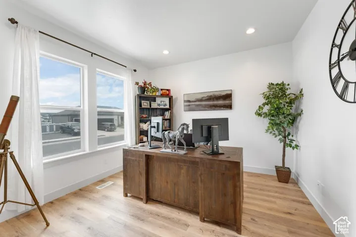 Bright interior space featuring wood-finish flooring, recessed lighting, and dual pane windows