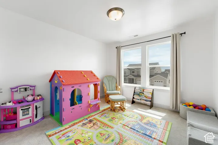 Bright room with dual windows, neutral wall color, and flush mount ceiling light