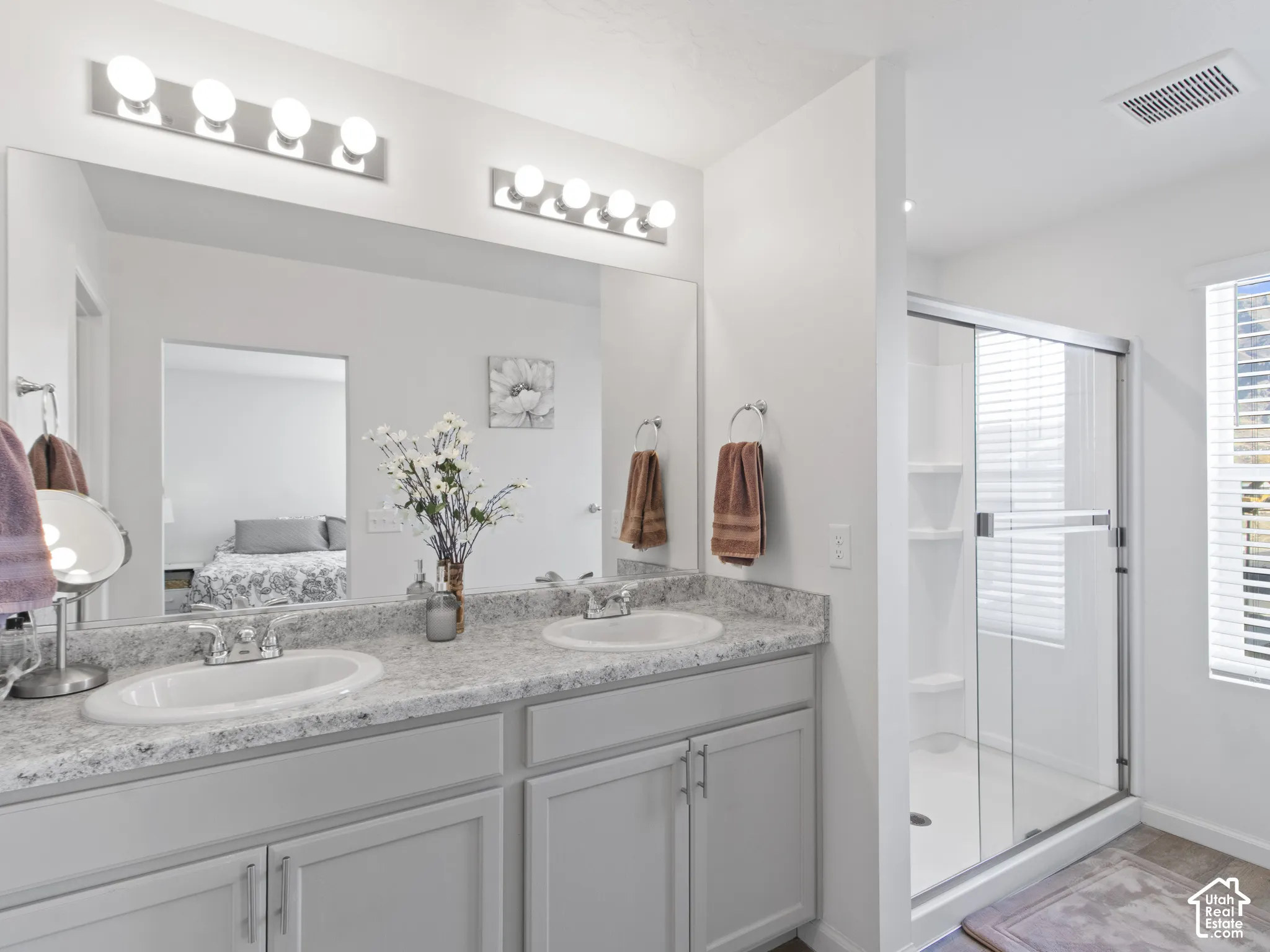 Dual vanity with white undermount sinks and light-toned countertops