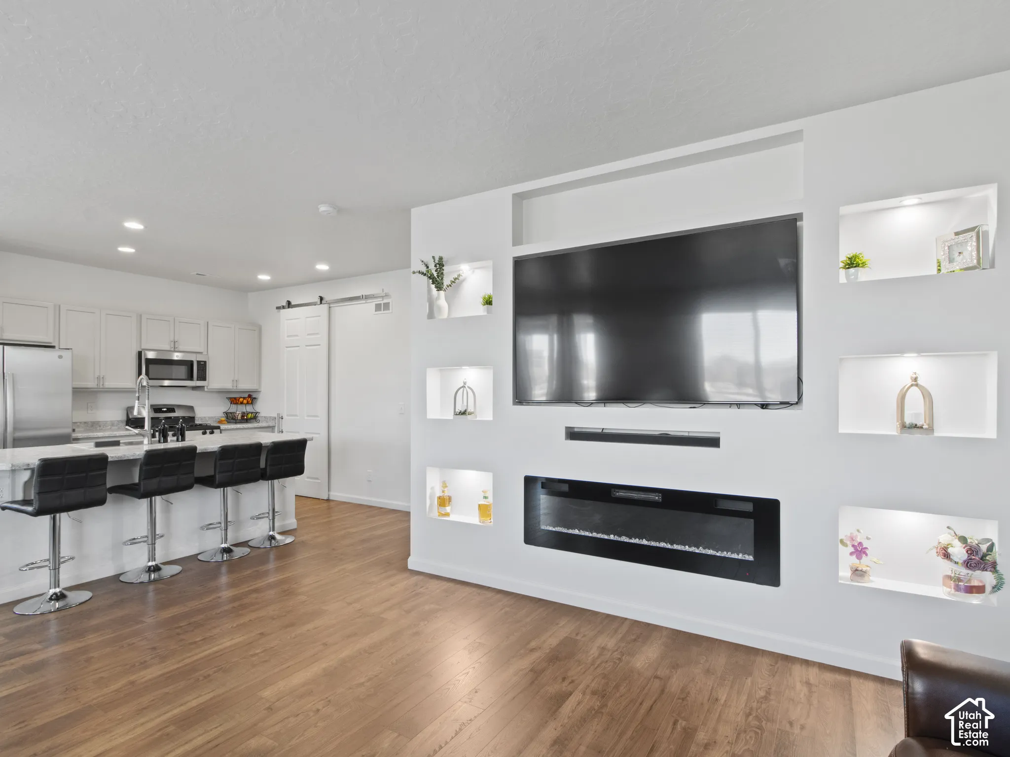 Built-in fireplace feature wall with integrated shelving and lighting