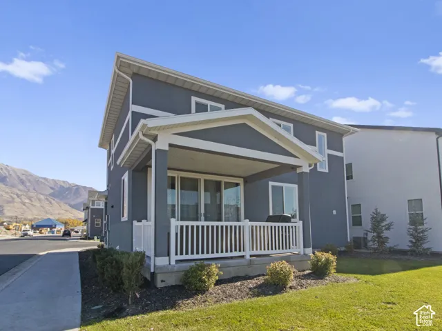 Two-story exterior with dark gray stucco siding and white trim