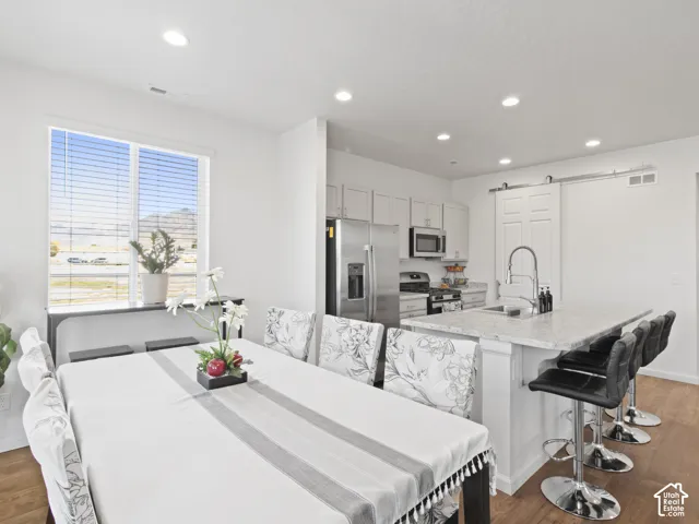 Open-concept living area with wood-finish flooring, recessed lighting, and a window with mountain scenery
