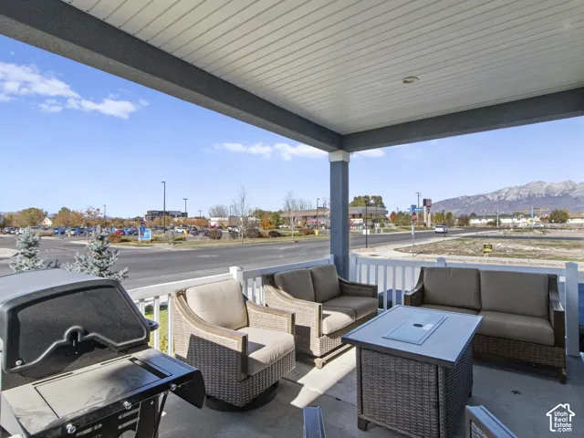 Covered porch with concrete flooring and white railing