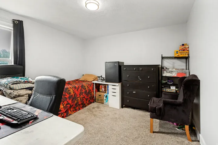 Wall-to-wall carpeting in a neutral tone, paired with light-colored walls