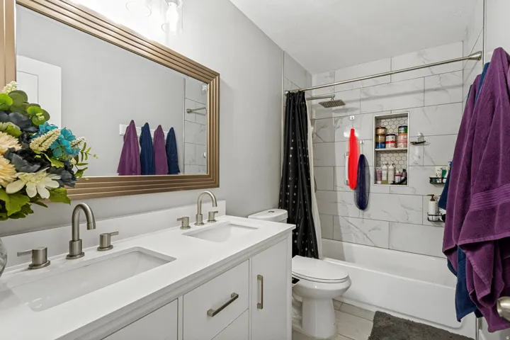 Dual vanity with undermount sinks, brushed nickel fixtures, and a white countertop