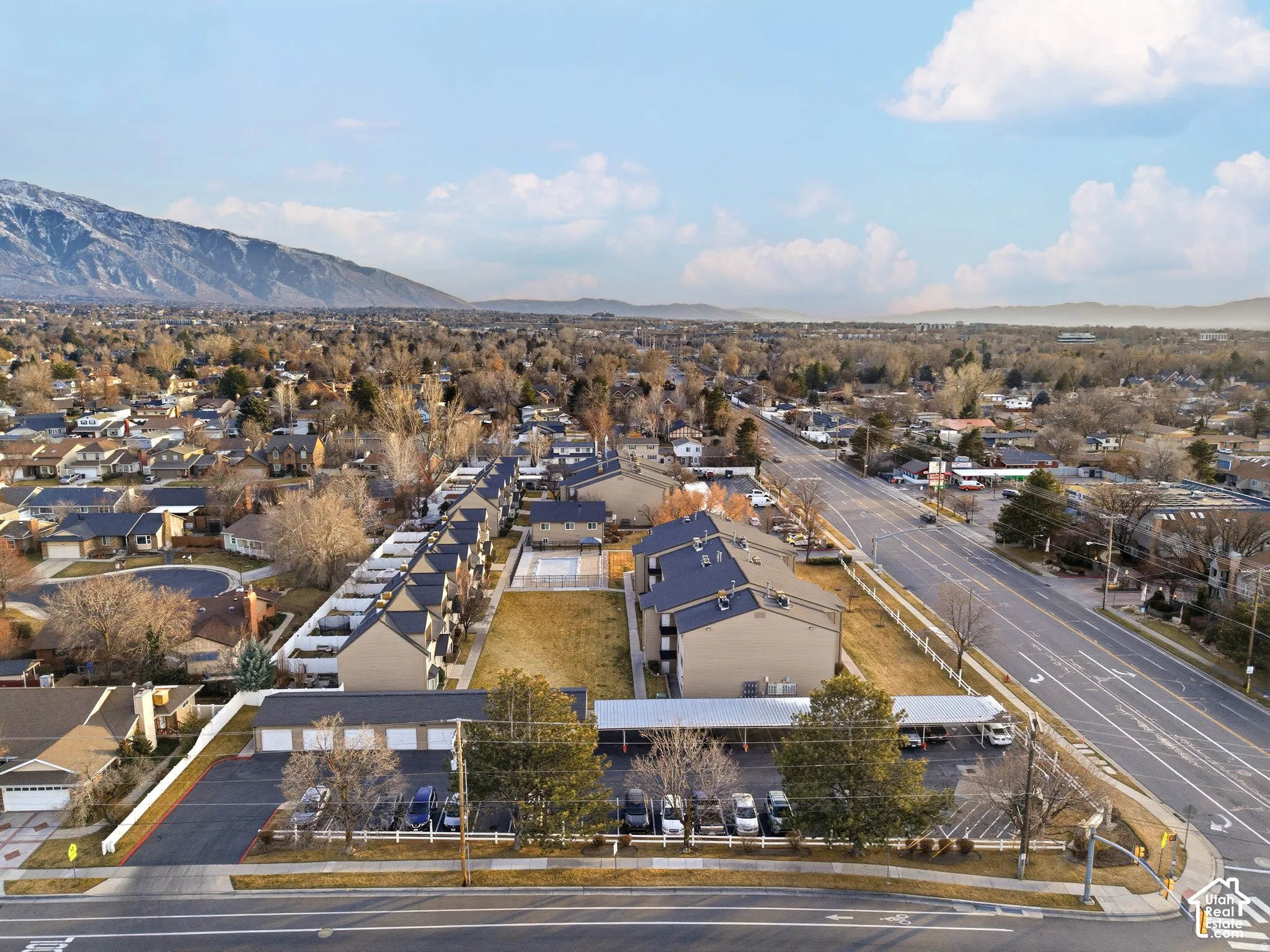 Townhome community featuring multi-story residences, dedicated surface parking, and covered parking structures
