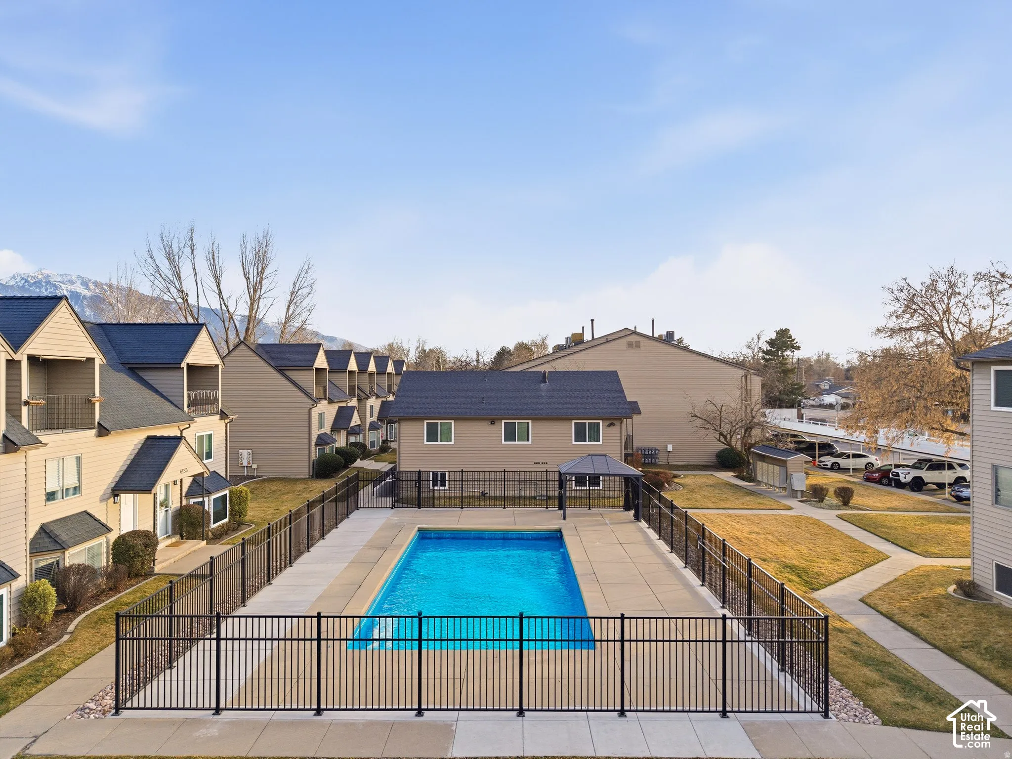 Fenced-in outdoor pool with surrounding concrete patio