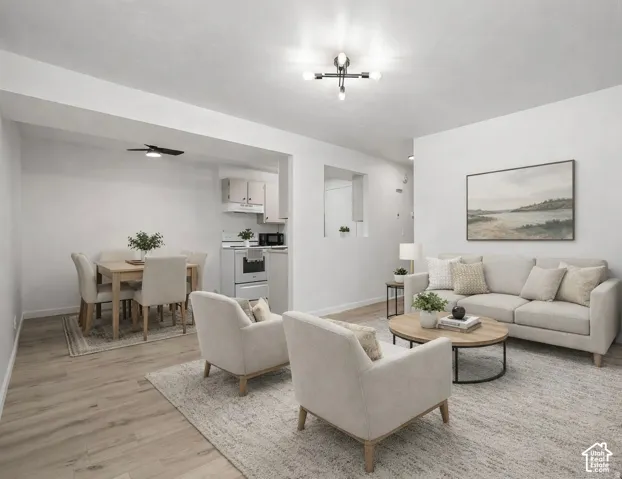 Open-concept living area featuring wood-finish flooring, recessed lighting, and a modern ceiling light fixture