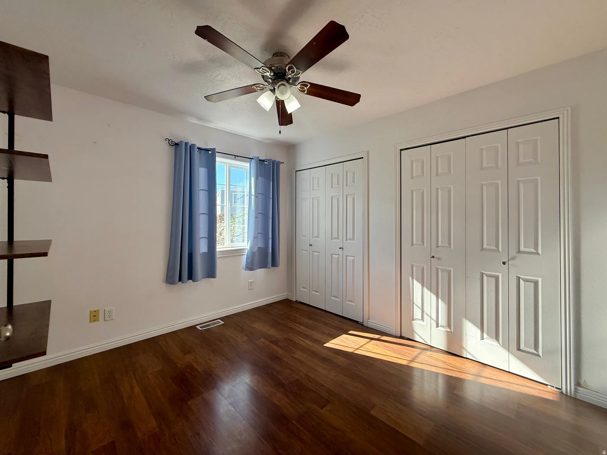 Wood-finish flooring with white baseboards