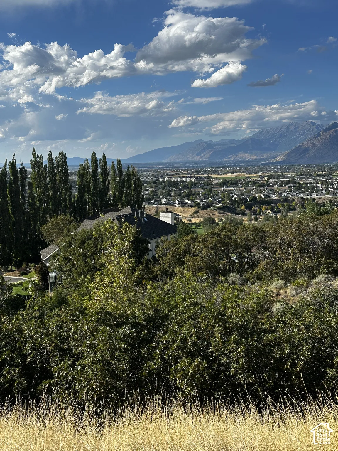 Expansive mountain backdrop with a distant cityscape
