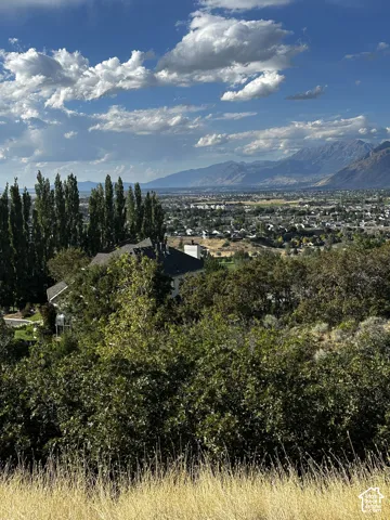 Expansive mountain backdrop with a distant cityscape