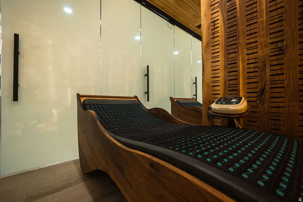 Wood-finish flooring, full-height glass panels, and a wood-finish wall panel