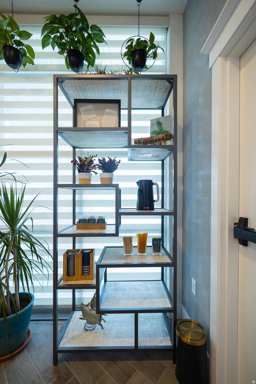 Metal-framed shelving unit with wood-finish shelf surfaces