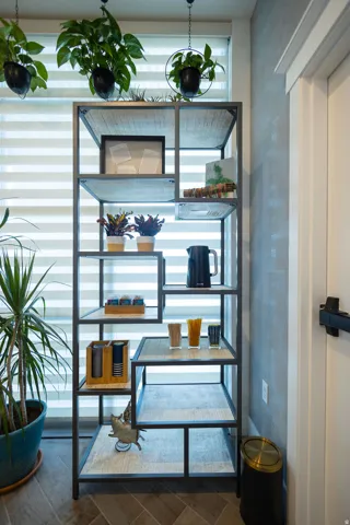 Metal-framed shelving unit with wood-finish shelf surfaces