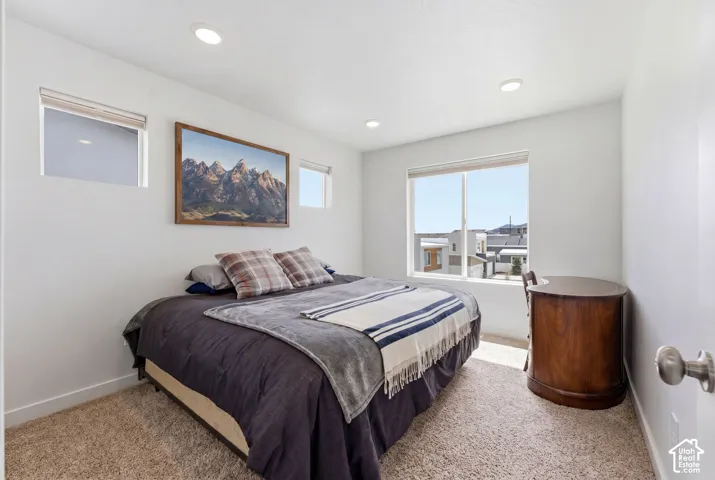 Neutral-toned interior featuring recessed lighting, wall-to-wall carpeting, and a large picture window