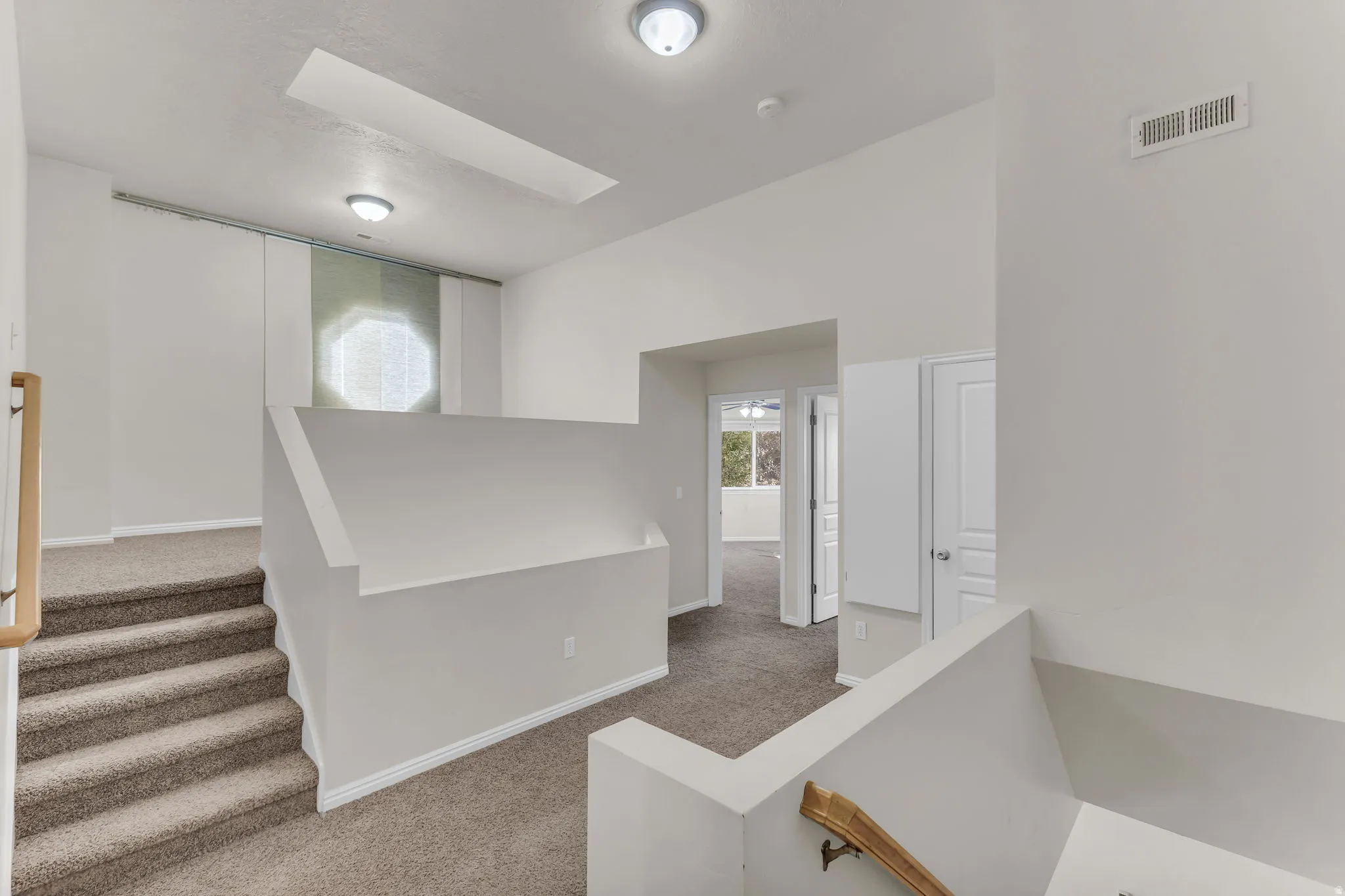 Upper level featuring carpeted flooring, white walls, and flush-mount lighting fixtures