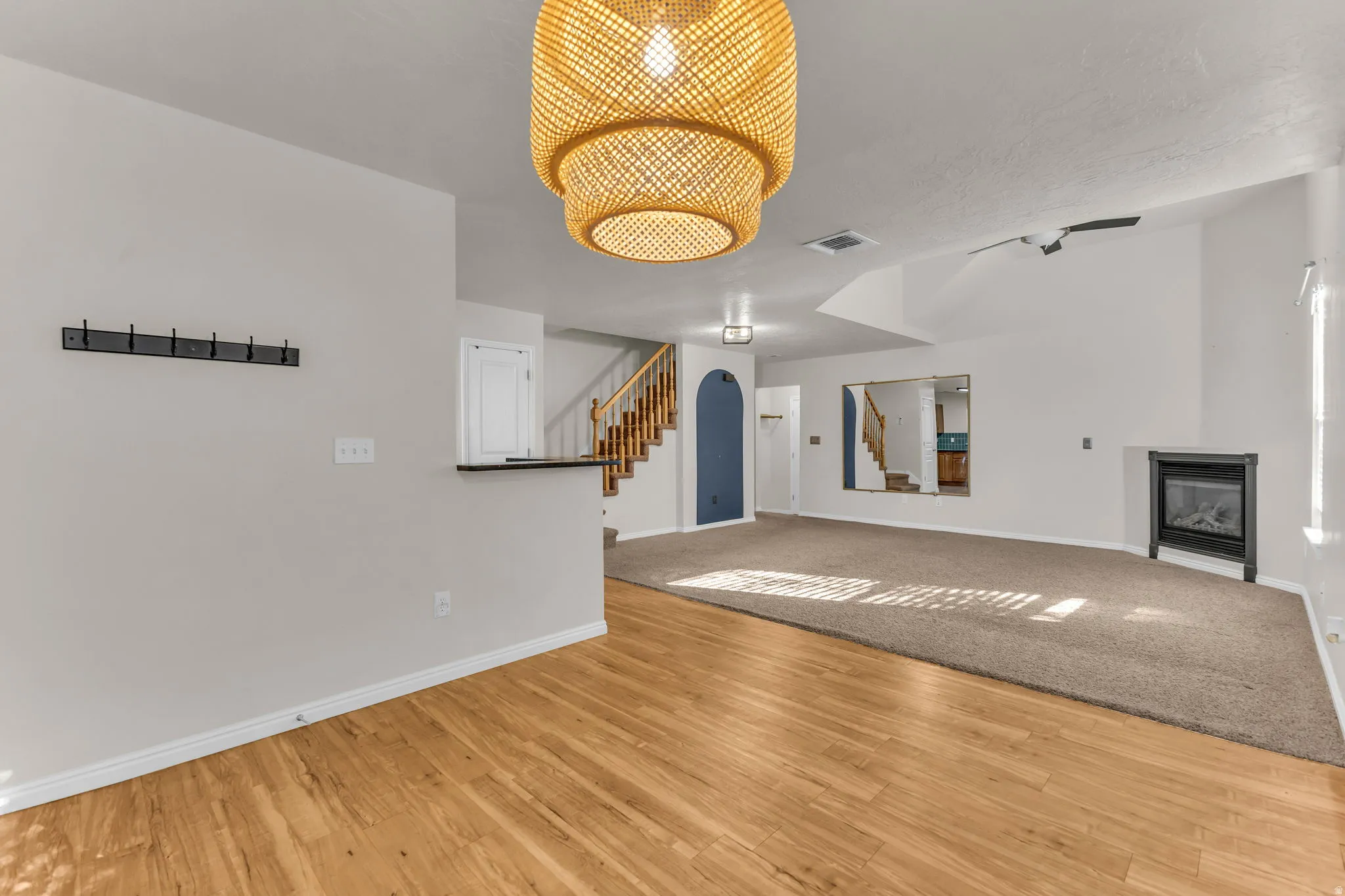 Wood-finish flooring with a woven pendant light fixture