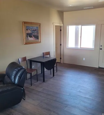 Wood-finish flooring throughout, neutral tone walls, and recessed lighting