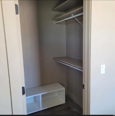 Built-in closet shelving system with hanging rods and integrated storage cubbies