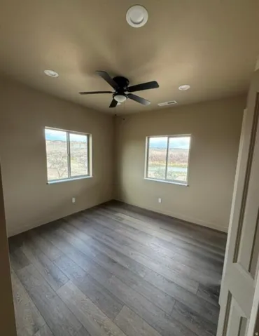 Wood-finish flooring, recessed lighting, and a ceiling fan with light fixture