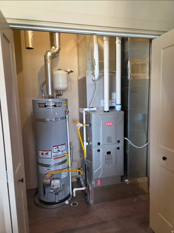 Water heater and furnace housed in a dedicated utility closet with wood-finish flooring