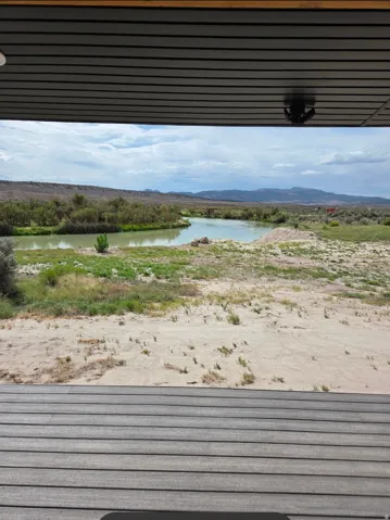 Expansive landscape featuring a meandering river and distant mountains