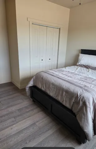 Wood-finish flooring with a neutral paint palette and bifold closet doors