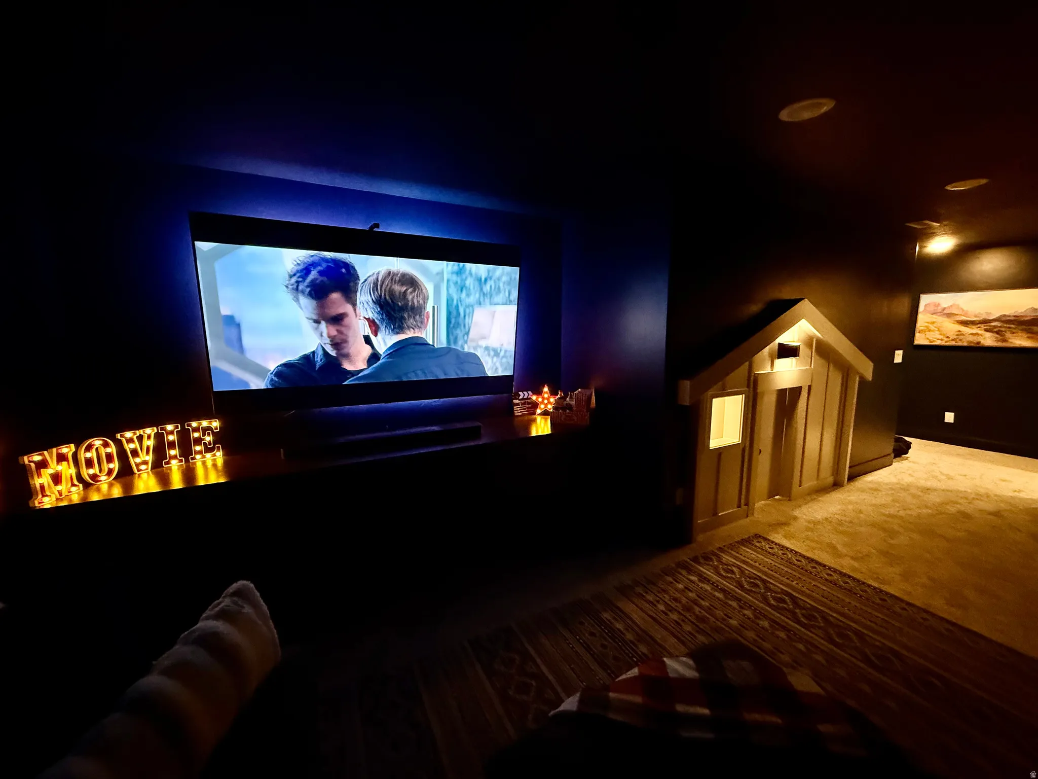 Built-in entertainment display with integrated lighting, recessed ceiling lighting, and a decorative built-in playhouse structure
