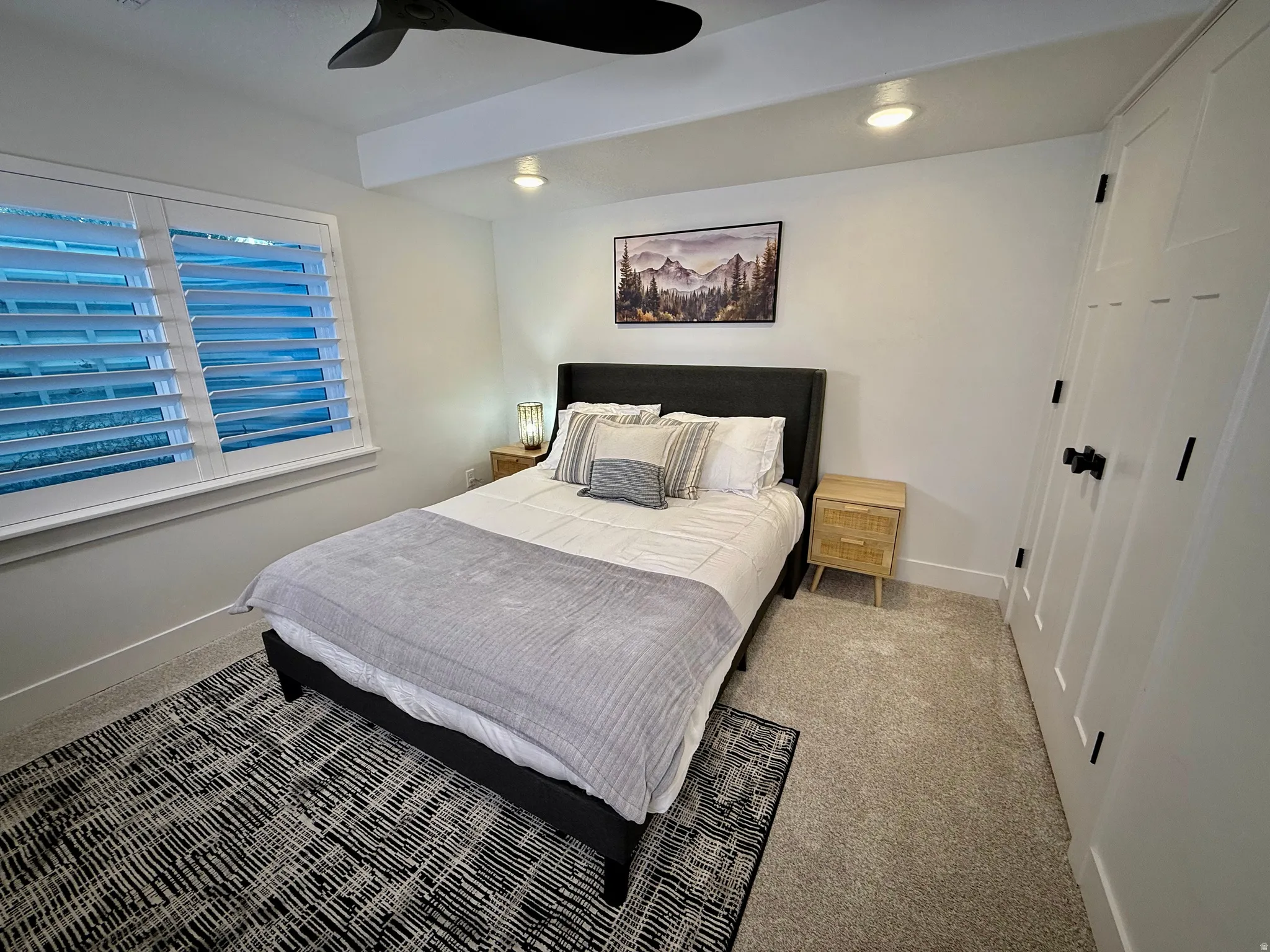 White plantation shutters, recessed ceiling lighting, ceiling fan, and carpeted flooring