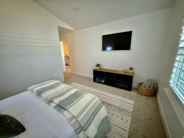 Recessed lighting, wall-mounted television, and carpeted flooring