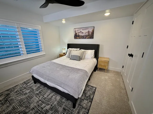 White plantation shutters, recessed ceiling lighting, ceiling fan, and carpeted flooring