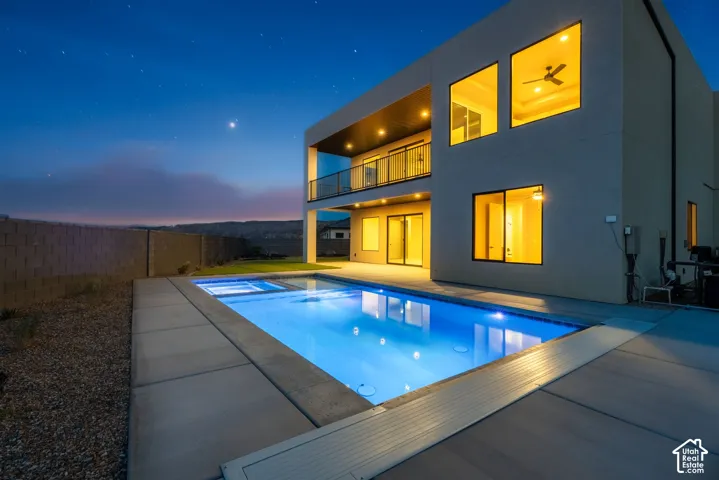 Contemporary exterior with a private swimming pool, integrated spa, and a second-story balcony