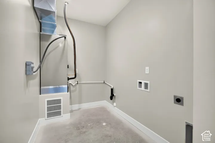 Utility room with a visible furnace and ductwork