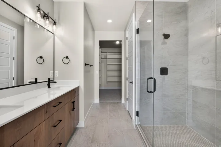 Dual vanity with wood-finish cabinetry and white countertops