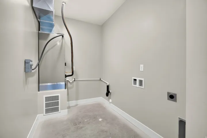 Utility room with a visible furnace and ductwork
