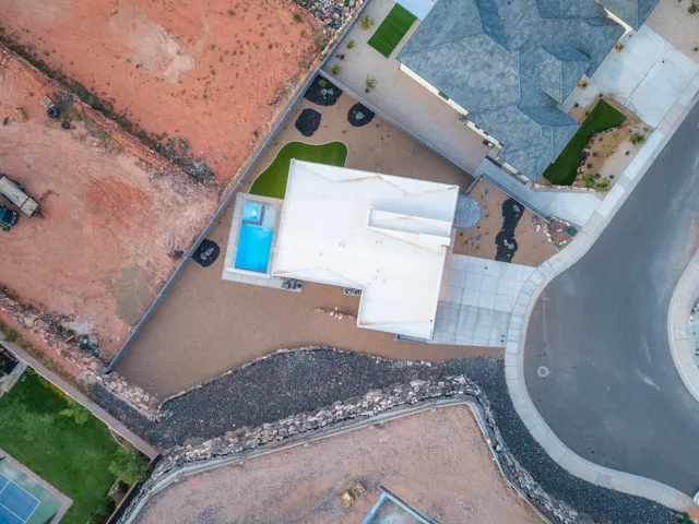 Modern exterior with a flat roof, integrated swimming pool, and concrete driveway