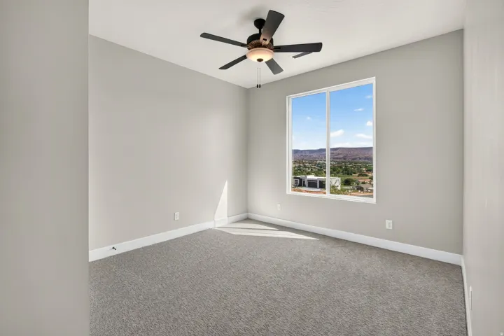 Recessed lighting, ceiling fan, carpeting, and a window with distant mountain scenery