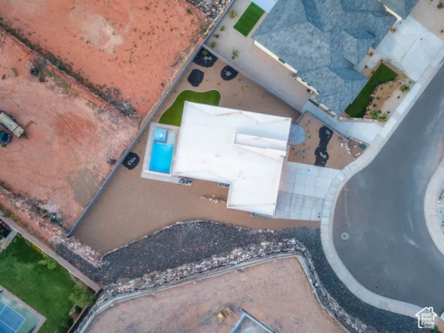 Modern exterior with a flat roof, integrated swimming pool, and concrete driveway