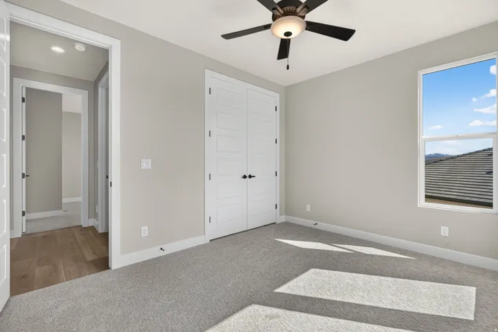 Neutral-toned walls complement plush carpeting