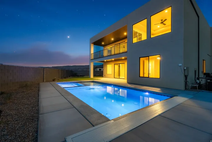 Contemporary exterior with a private swimming pool, integrated spa, and a second-story balcony