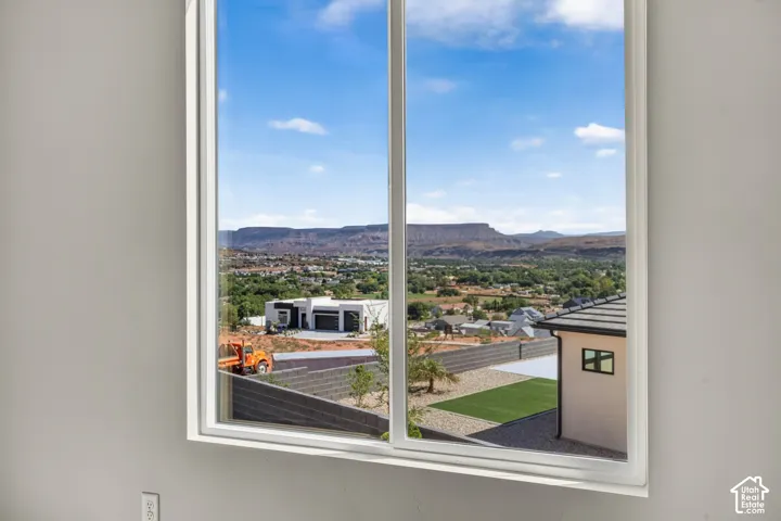 Large window framing a distant mountain landscape and urban surroundings
