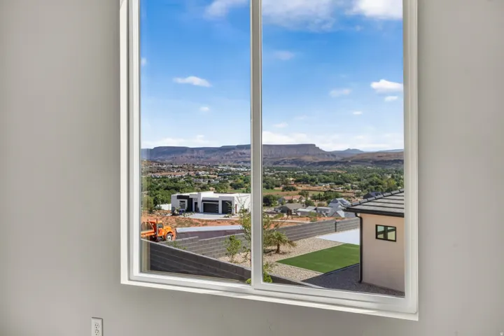 Large window framing a distant mountain landscape and urban surroundings
