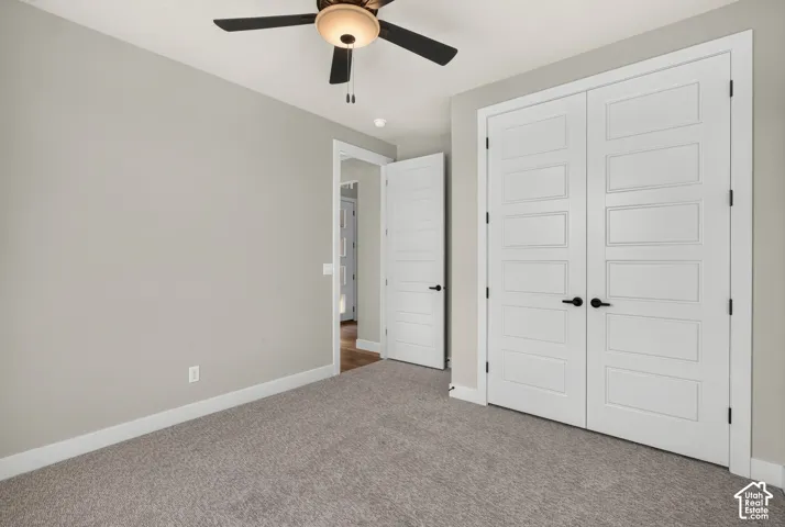 Neutral-toned walls complement the gray carpeting